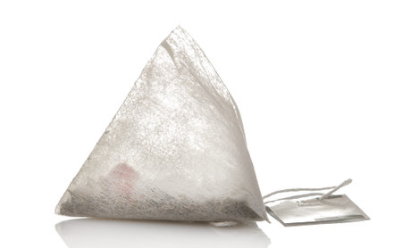 tea bag pyramid closeup on white isolated background. tea. to make teaの写真素材