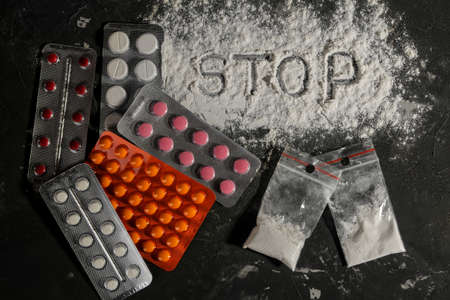 addictive drugs. LSD and the word cocaine on the black table. The concept of drug addiction. view from aboveの写真素材