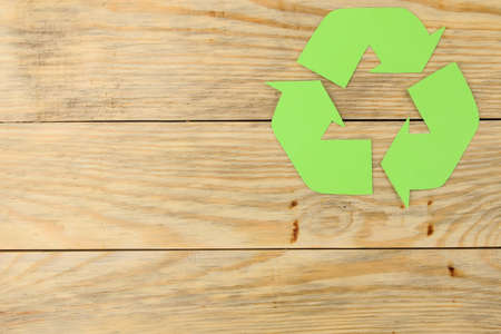 Recycling sign on a natural wooden table. view from above. eco conceptの写真素材