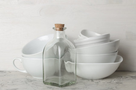 A stack of dishes. tableware on a light concrete background. dishes for serving the table. bowls and...