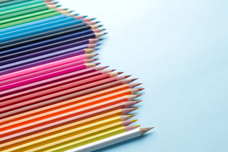 Composition with colored pencils on a bright blue background. close-up. space for textの写真素材