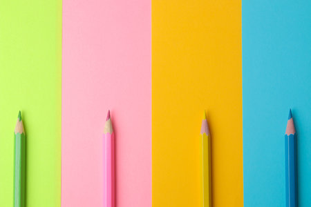 Composition with colored pencils on a colorful trendy background. top view. space for text