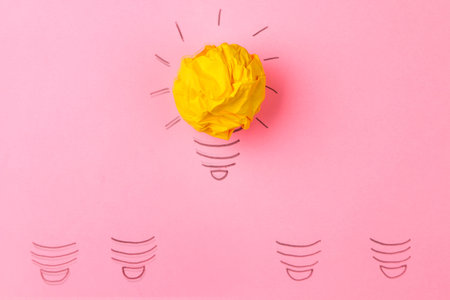 Concept creative idea. concept of creative idea. Crumpled paper balls and painted light bulb on...