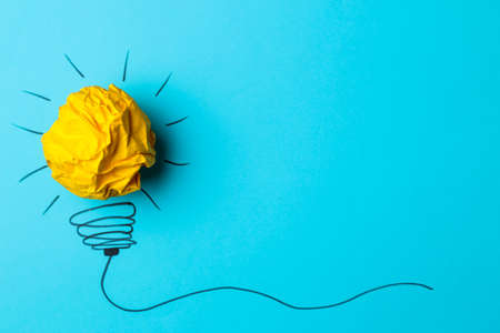 Concept creative idea. concept of creative idea. Crumpled paper balls and painted light bulb on bright background. metaphor, inspiration.の写真素材