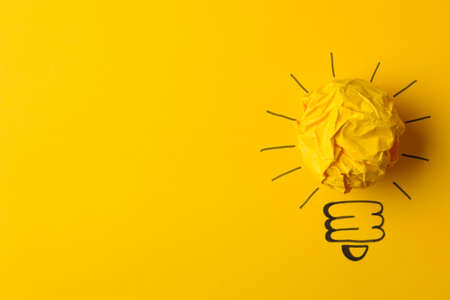 Concept creative idea. concept of creative idea. Crumpled paper balls and painted light bulb on bright background. metaphor, inspiration.の写真素材