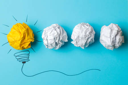 Concept creative idea. concept of creative idea. Crumpled paper balls and painted light bulb on bright background. metaphor, inspiration.の写真素材