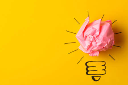 Concept creative idea. concept of creative idea. Crumpled paper balls and painted light bulb on bright background. metaphor, inspiration.の写真素材