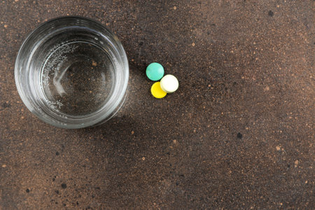 Depression concept. Psychological illness. a glass with water and a tablet on a dark background....