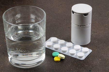 Depression concept. Psychological illness. a glass with water and a tablet on a dark background....