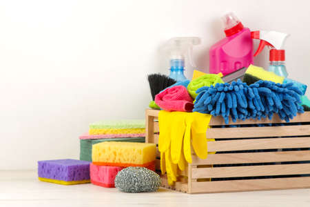Bottles with detergent and cleaning tools on a light background. cleaning. cleaning products. free place. space for textの写真素材