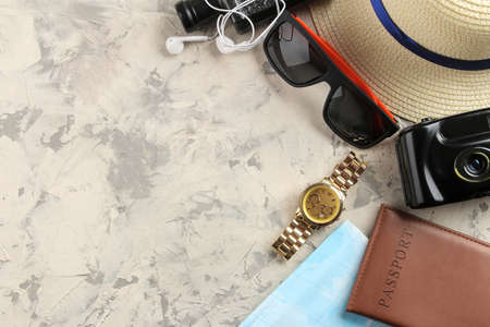 Travel concept hat, passport, map, camera and sunglasses on a light concrete background. top viewの写真素材
