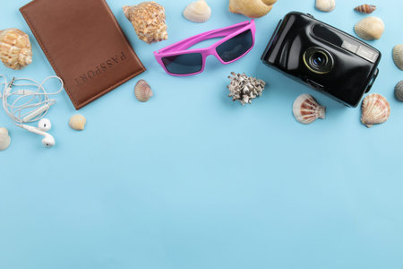 Travel concept. Passport, camera, and glasses on a bright blue background. top view. space for text