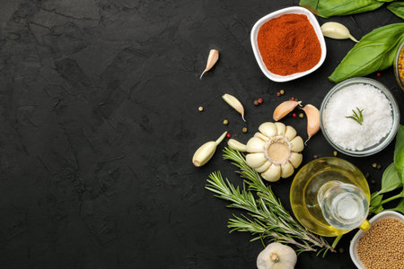 herbs and spices. various seasonings, herbs and spices on a graphite black background. top view....