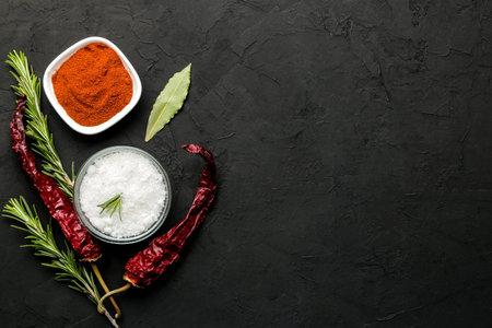 herbs and spices. various seasonings, herbs and spices on a graphite black background. top view....