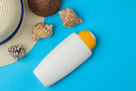 Sunscreen. various sunscreens and beach accessories on a bright blue background. summer. vacation....