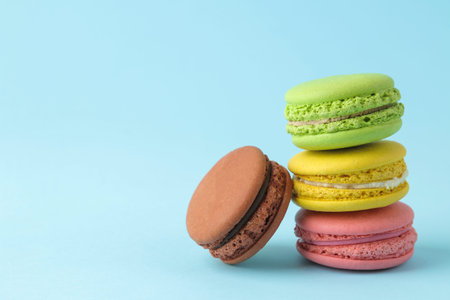 Macarons french multicolored macaroons cakes. small french sweet cake on bright blue background....
