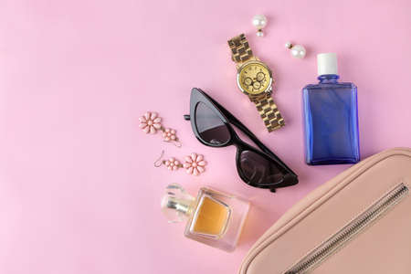 Stylish fashionable pink bag and women's cosmetics and accessories on a bright trendy pink background. female accessory concept. top viewの写真素材