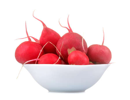 Fresh radish in bowl on white isolated background. Spring Spring vegetables. close-upの写真素材