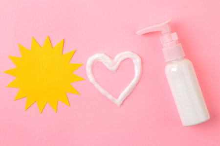 sunscreen remedy. various sunscreens and a cream heart against a bright pink background. Sun...