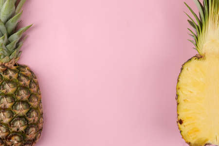 Large ripe fruit pineapple on a bright pink background. summer. top view. space for textの写真素材