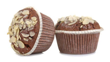 Delicious, sweet chocolate muffins, with almond petals on a white isolated background.の写真素材