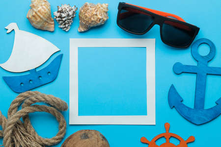 Summer frame. paper frame for your text, coconut and nautical rope and summer accessories on a bright light blue background. top viewの写真素材