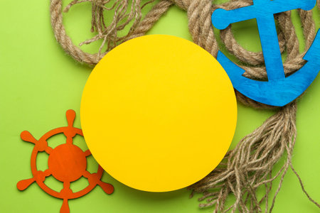 Summer frame. paper frame for your text, rope and decorative nautical steering wheel and anchor on a...