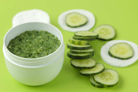 Face mask with cucumber. Cosmetics with cucumber extract on a bright green background. spa. beauty.の写真素材