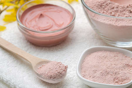 Cosmetic clay. Pink cosmetic clay in different types on a white wooden table. face mask and body. care products. spa.の写真素材