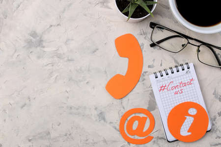 client support service. Contact us for feedback. Desktop with notepad and glasses and various feedback icons. top viewの写真素材