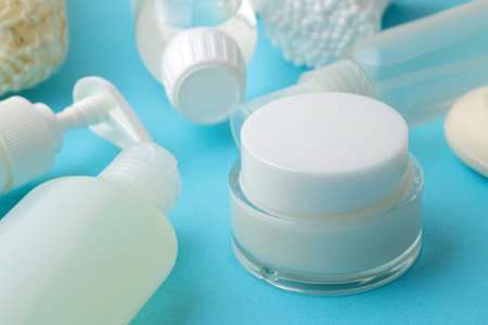 Personal hygiene products. Body care cosmetics. White bottles and vials on a blue background. SPA...