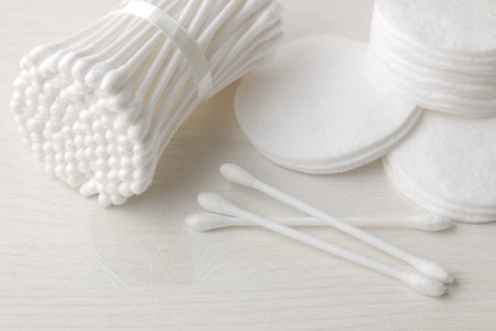 Various personal care products. Cotton pads and sticks on a white background close-up