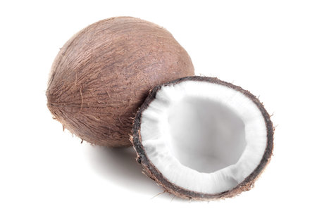 Whole coconut and half coconut on a white background isolated