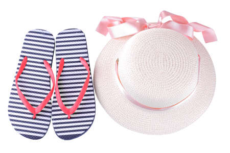 Summer hat with a pink ribbon and flip flops in blue and white stripes. Isolatedの写真素材