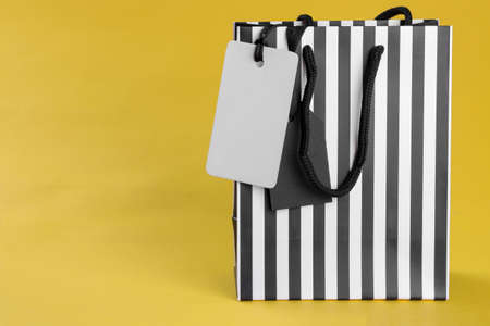 Black Friday. The concept of shopping. sale. Shopping bag and price tag sale on yellow backgroundの写真素材