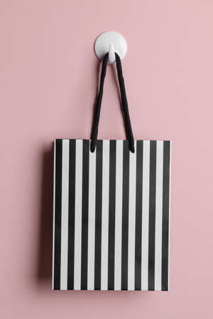Black Friday. The concept of shopping. sale. The package is hanging on a hook on the background of the wall.の写真素材