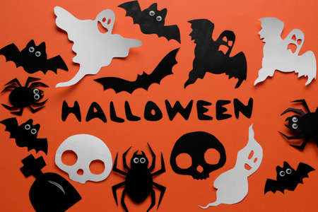The concept of the holiday of Halloween. bats of the cast and spiders on an orange background. top viewの写真素材