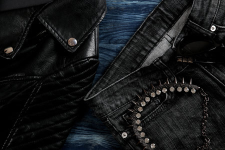 Set of stylish black women's clothing, women's fashion accessories, black style, on blue wooden...