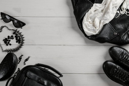 Set of stylish black women's clothing, women's fashion accessories, black style, on white wooden background. flat lay, top viewの写真素材