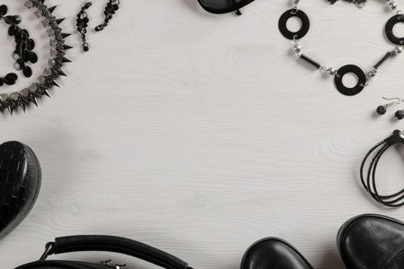 Set of stylish black women's clothing, women's fashion accessories, black style, on white wooden background. flat lay, top viewの写真素材