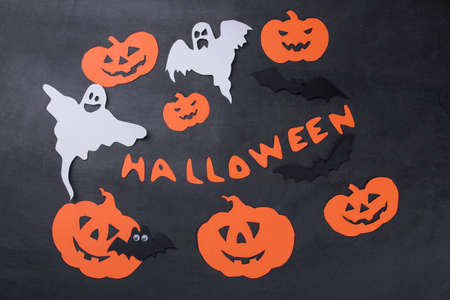 Halloween holiday. Composition with different halloween paper figures. view from above. on a dark backgroundの写真素材