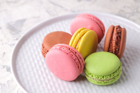 Macaroons on a light background. Sweet French cake, different types of macarons.の写真素材