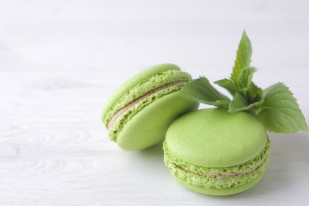 Green macaroons on a light background. Sweet French cake.の写真素材