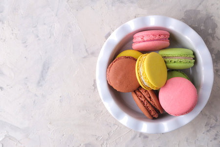 Macaroons on a light background. Sweet French cake, different types of macarons.の写真素材