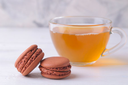 Macaroons and tea on a light background. Sweet French cake.の写真素材