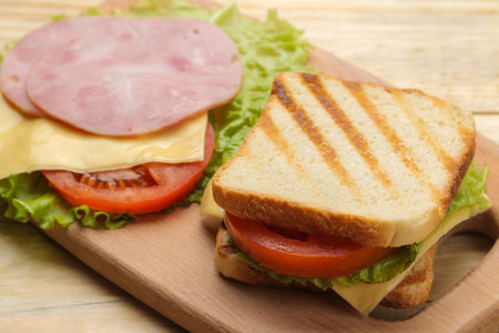 Close-up sandwich with ham cheese and tomato on wooden backgroundの写真素材