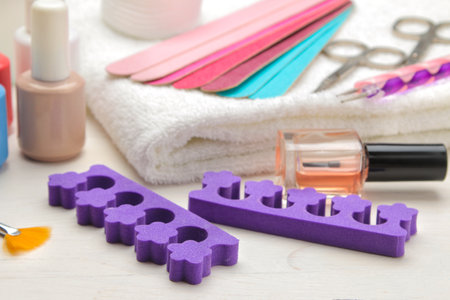 Manicure and pedicure tools, file, nail polish and scissors, finger separators.の写真素材