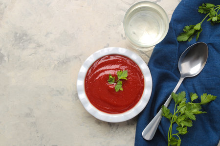 Delicious, fresh tomato soup on the table and parsleyの写真素材