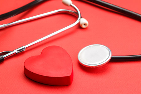 Stethoscope and red heart on a red background. heart health and medical care.の写真素材
