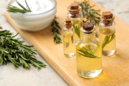 Rosemary essential oil and cream on a light background. face and body skincare. spa.の写真素材